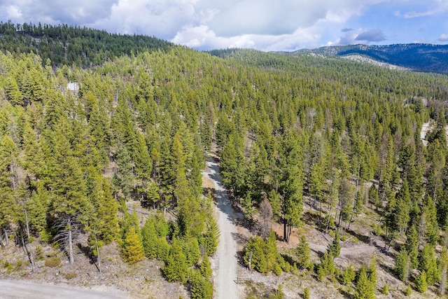 aerial view featuring a forest view and a mountain view