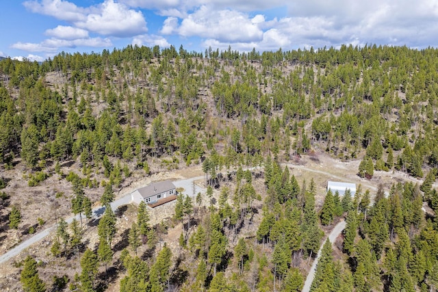 bird's eye view featuring a wooded view