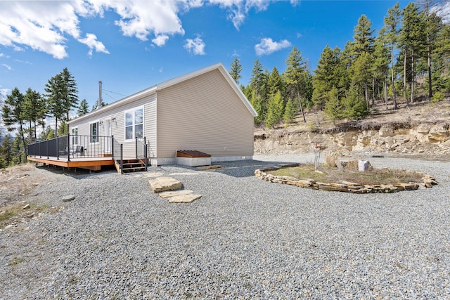 view of side of home with a deck