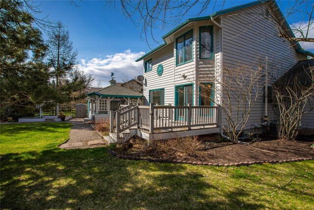 view of side of home with a wooden deck, a gazebo, and a yard