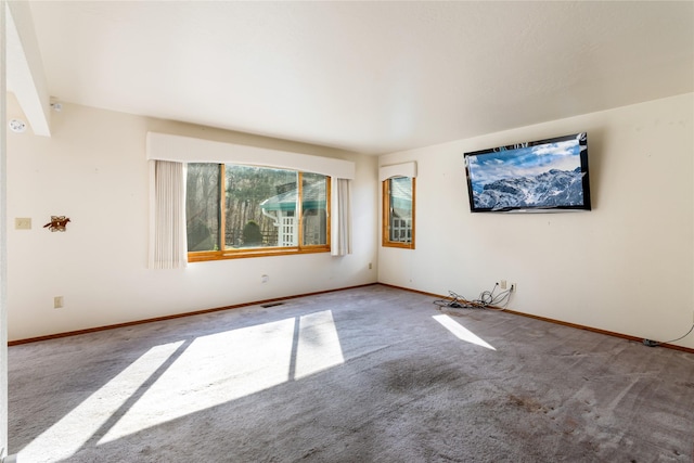empty room with baseboards and carpet flooring