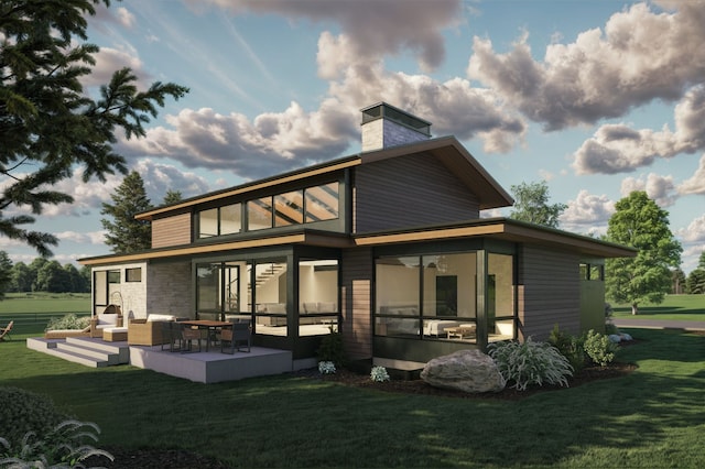 10695 Royal Coachman Dr, Missoula, MT 59808 - rear view of property featuring a chimney, a yard, a sunroom, and outdoor lounge area
