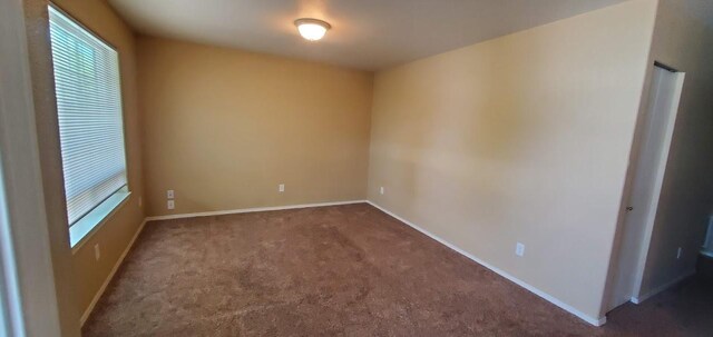 1034 Main St, Corvallis, MT 59828 - carpeted spare room with a wealth of natural light and baseboards