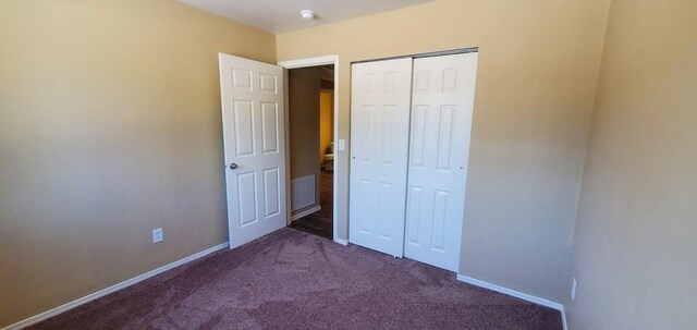 1034 Main St, Corvallis, MT 59828 - unfurnished bedroom featuring dark colored carpet, baseboards, and a closet