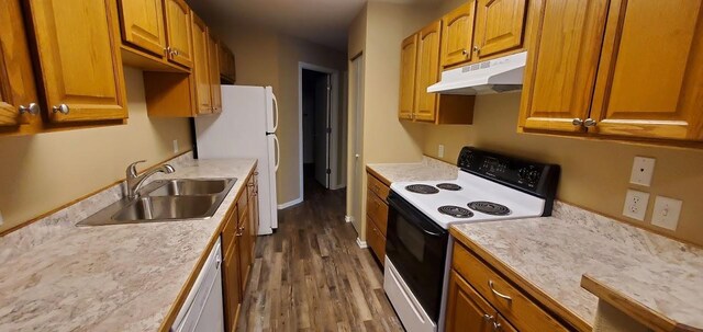 1034 Main St, Corvallis, MT 59828 - kitchen featuring a sink, white appliances, light countertops, dark wood finished floors, and under cabinet range hood