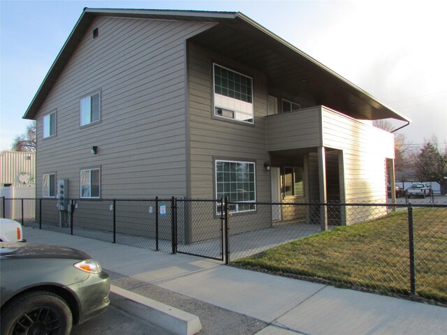 1034 Main St, Corvallis, MT 59828 - view of home's exterior featuring a gate, a yard, and fence private yard
