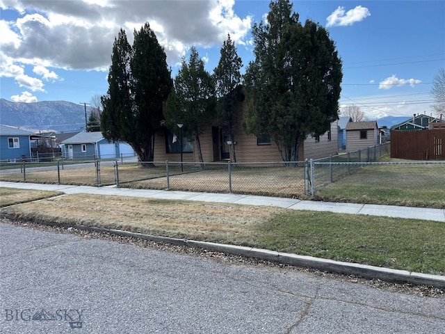 obstructed view of property featuring a mountain view and a fenced front yard