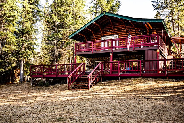 view of front of property with log siding and a deck