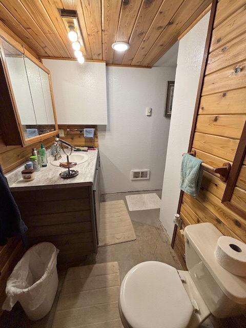 2025 Emmons Canyon Rd, Kila, MT 59920 - bathroom featuring wood ceiling, vanity, toilet, baseboards, and tile patterned flooring