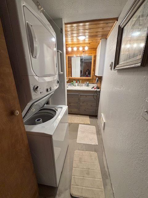 2025 Emmons Canyon Rd, Kila, MT 59920 - bathroom with estacked washer and dryer, a textured ceiling, a textured wall, and vanity