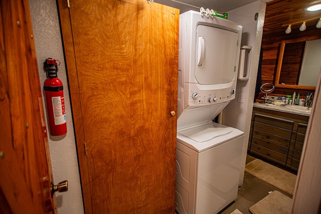 washroom with stacked washer / dryer and laundry area