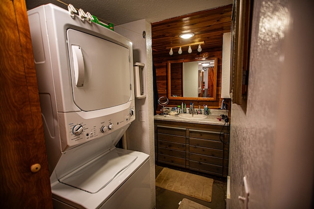 bathroom with vanity and stacked washer / dryer