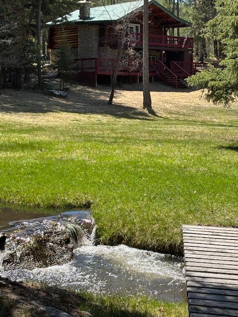 2025 Emmons Canyon Rd, Kila, MT 59920 - view of grassy yard featuring a deck and stairs