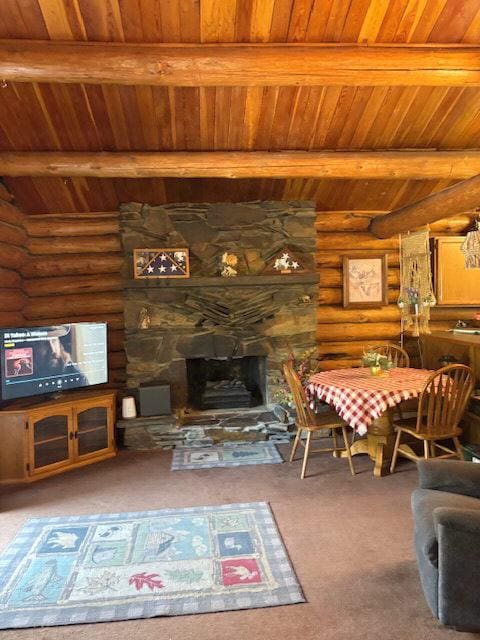 carpeted living room with a stone fireplace, wooden ceiling, rustic walls, and beam ceiling
