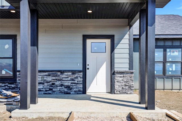 entrance to property featuring stone siding