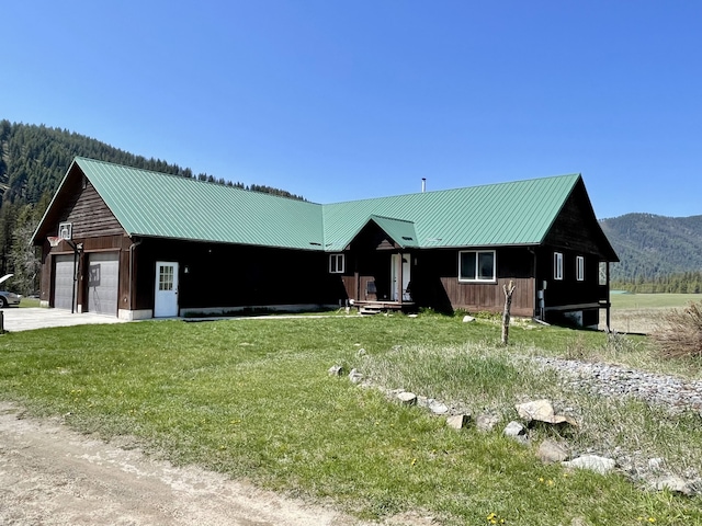 398 Little Beaver Creek Rd, Trout Creek, MT 59874 - view of front of home featuring driveway, a front yard, metal roof, and a mountain view