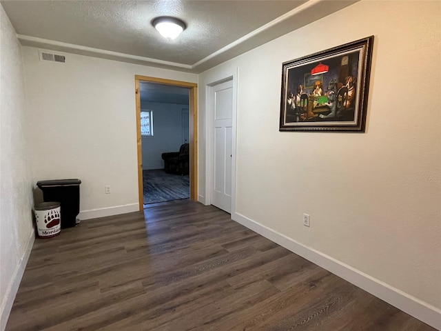 398 Little Beaver Creek Rd, Trout Creek, MT 59874 - empty room featuring dark wood-type flooring, a textured ceiling, visible vents, and baseboards