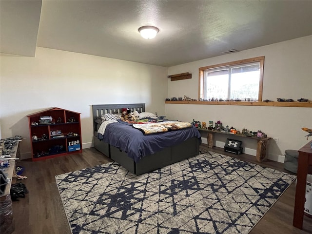 398 Little Beaver Creek Rd, Trout Creek, MT 59874 - bedroom with baseboards, wood finished floors, and visible vents
