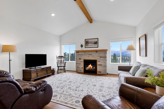 living area featuring beamed ceiling, wood finished floors, a fireplace, and high vaulted ceiling