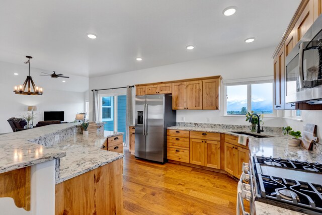 kitchen with recessed lighting, a kitchen breakfast bar, dark wood-style floors, stainless steel appliances, and a center island