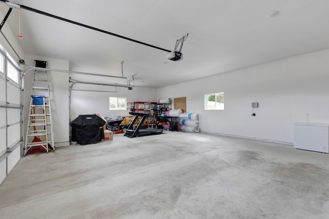 garage with refrigerator and a garage door opener
