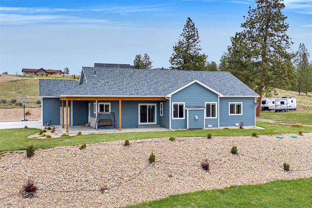 view of front of property with a shingled roof and a front yard