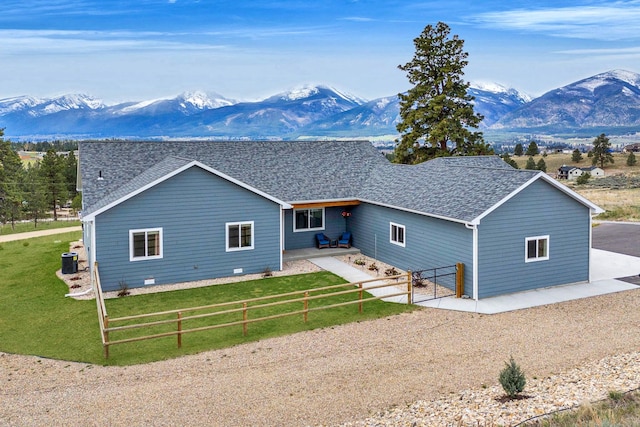 back of property with a patio area, a fenced backyard, and a mountain view