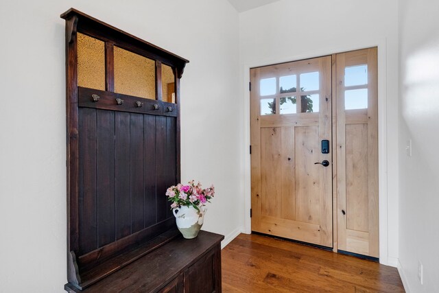 entrance to property featuring roof with shingles