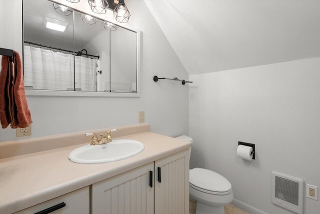 343 Deer Trl, Whitefish, MT 59937 - bathroom with toilet, vaulted ceiling, heating unit, a shower with shower curtain, and vanity
