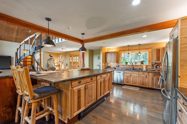 kitchen featuring beamed ceiling, dark countertops, backsplash, and appliances with stainless steel finishes