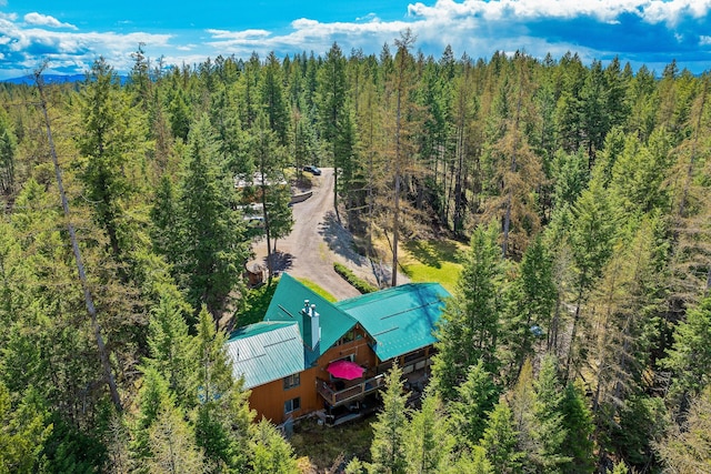 birds eye view of property featuring a view of trees