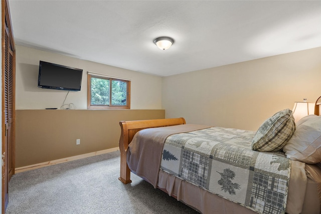 bedroom with baseboards and carpet