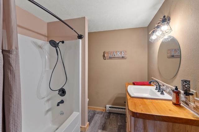full bathroom featuring wood finished floors, vanity, a baseboard heating unit, baseboards, and bathtub / shower combination