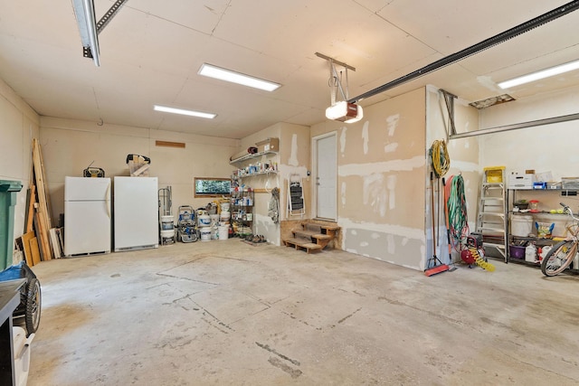 garage with a garage door opener and freestanding refrigerator