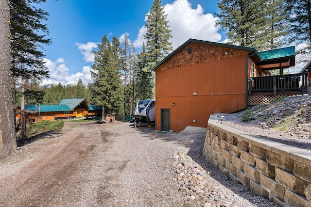 view of property exterior with dirt driveway