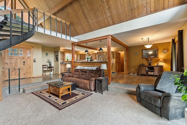 living area with carpet, stairs, high vaulted ceiling, and a healthy amount of sunlight
