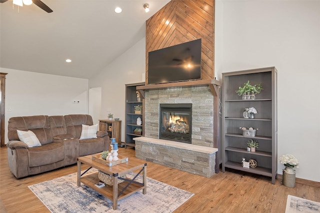 2277 Spring Wheat Loop, East Helena, MT 59635 - living area with high vaulted ceiling, a ceiling fan, a stone fireplace, wood finished floors, and recessed lighting