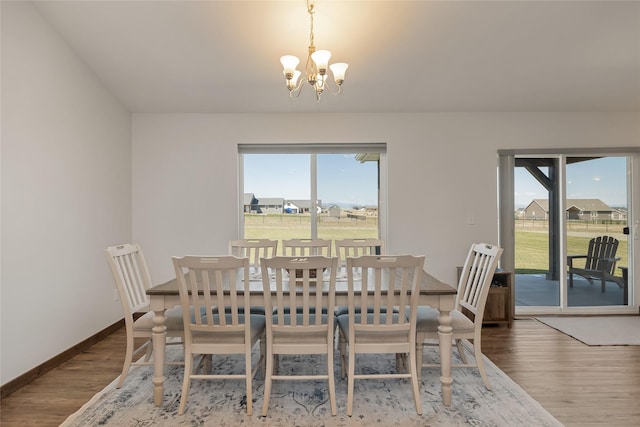 2277 Spring Wheat Loop, East Helena, MT 59635 - dining room with a chandelier, wood finished floors, and baseboards