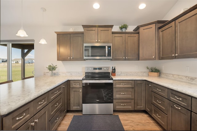 2277 Spring Wheat Loop, East Helena, MT 59635 - kitchen with stainless steel appliances, a peninsula, light wood-type flooring, recessed lighting, and pendant lighting