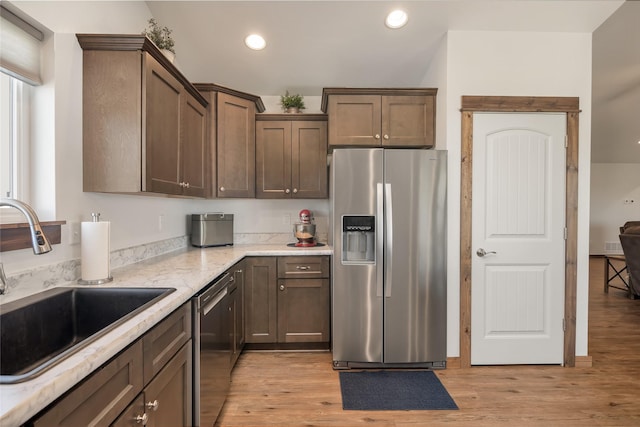 2277 Spring Wheat Loop, East Helena, MT 59635 - kitchen with appliances with stainless steel finishes, a sink, recessed lighting, light wood finished floors, and light stone counters