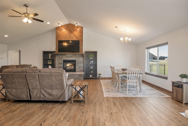 2277 Spring Wheat Loop, East Helena, MT 59635 - living room featuring lofted ceiling, a chandelier, baseboards, wood finished floors, and a ceiling fan