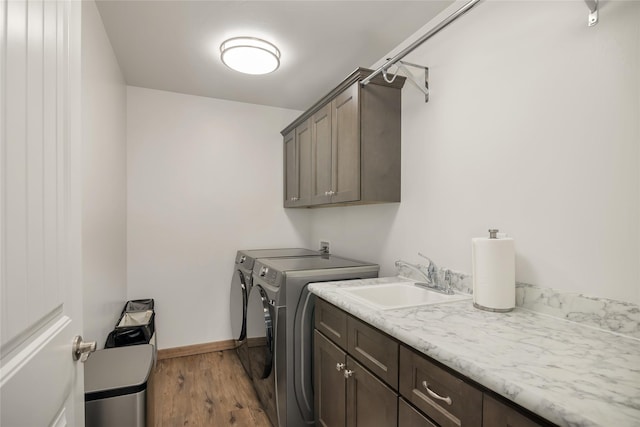 2277 Spring Wheat Loop, East Helena, MT 59635 - laundry room with cabinet space, washer and dryer, wood finished floors, and baseboards