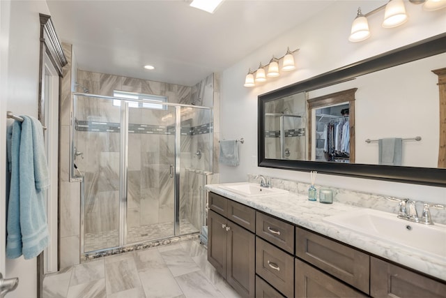 2277 Spring Wheat Loop, East Helena, MT 59635 - full bathroom featuring double vanity, a stall shower, a spacious closet, and marble look tiles