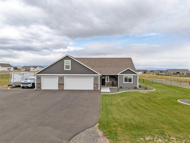 2277 Spring Wheat Loop, East Helena, MT 59635 - craftsman-style home with stone siding, driveway, a garage, and covered porch