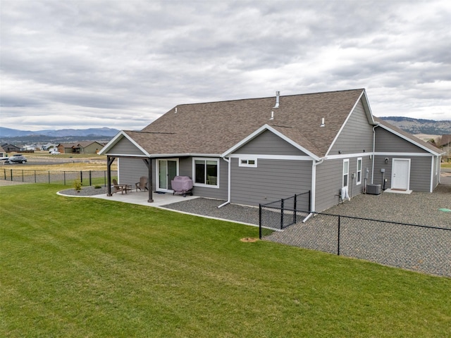 2277 Spring Wheat Loop, East Helena, MT 59635 - rear view of house with roof with shingles, a patio area, a mountain view, and cooling unit