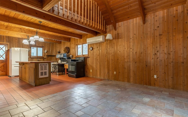 1298 E Mountain Meadow Rd, Kalispell, MT 59901 - kitchen featuring black / electric stove, freestanding refrigerator, a wall unit AC, a wooden ceiling with exposed beams, and wooden walls
