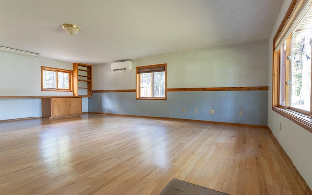 1298 E Mountain Meadow Rd, Kalispell, MT 59901 - empty room featuring a wall mounted air conditioner and light wood-style flooring