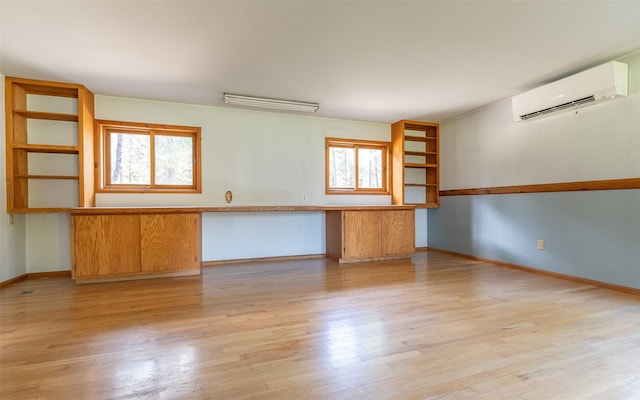 1298 E Mountain Meadow Rd, Kalispell, MT 59901 - empty room featuring an AC wall unit and light wood-style flooring