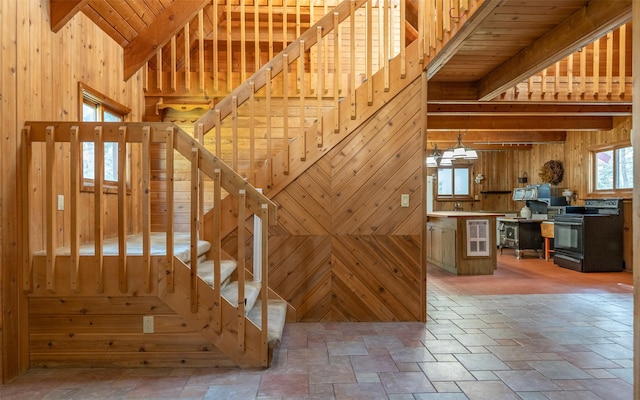 1298 E Mountain Meadow Rd, Kalispell, MT 59901 - stairway featuring wooden walls, stone tile flooring, beam ceiling, and wine cooler
