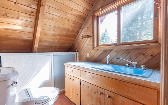 1298 E Mountain Meadow Rd, Kalispell, MT 59901 - half bath with wooden walls, vanity, tile patterned flooring, vaulted ceiling, and wooden ceiling
